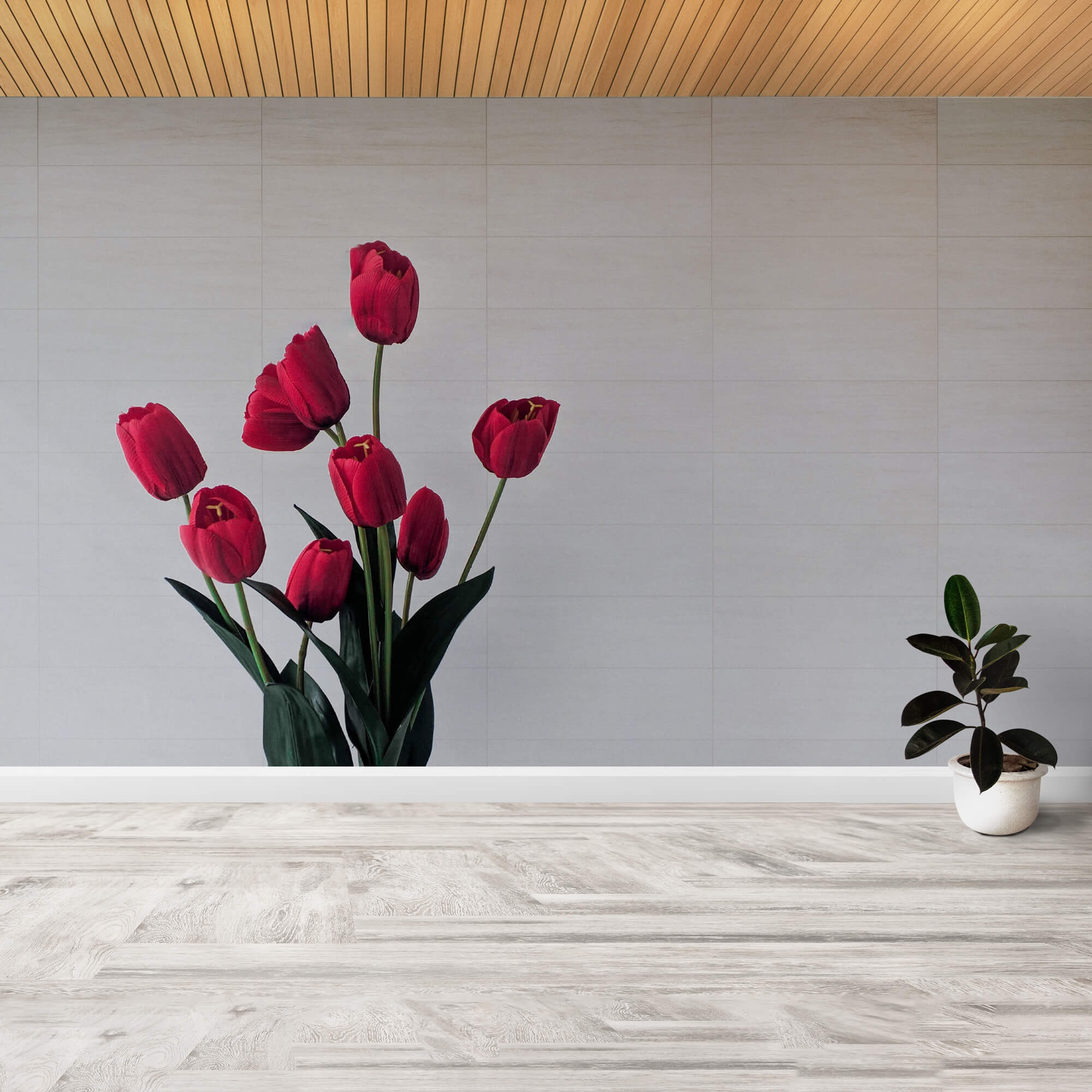 Imagen de la pared de un estudio de yoga, rotulada con un vinilo de un ramo de unos tulipanes rojos sobre un fondo liso de color gris claro.